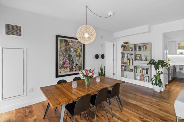 a view of a dining room with furniture wooden floor and a chandelier