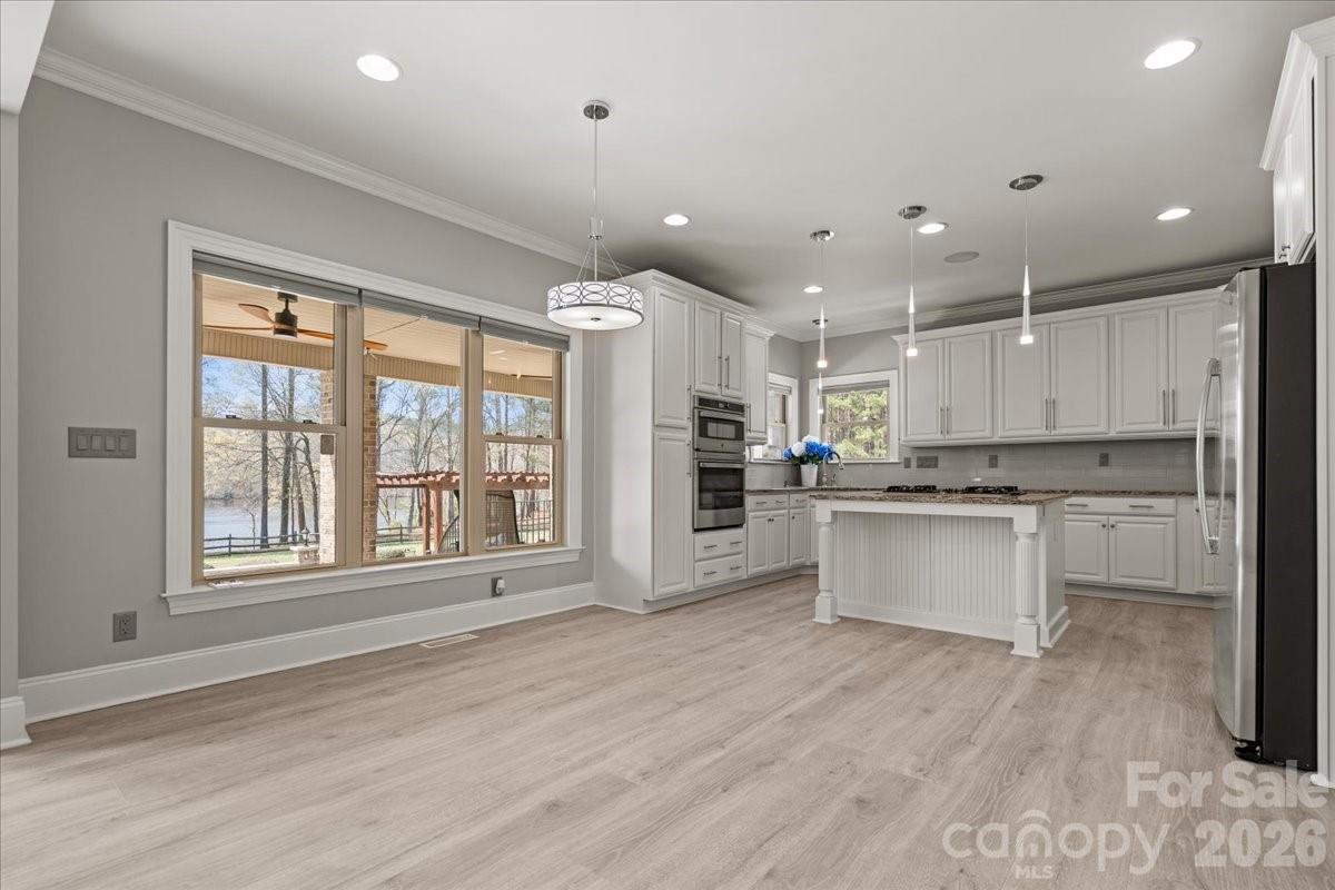 962 Miller Road Jefferson, SC 29718 - Photo 18 of 48 a large white kitchen with large windows and white appliances