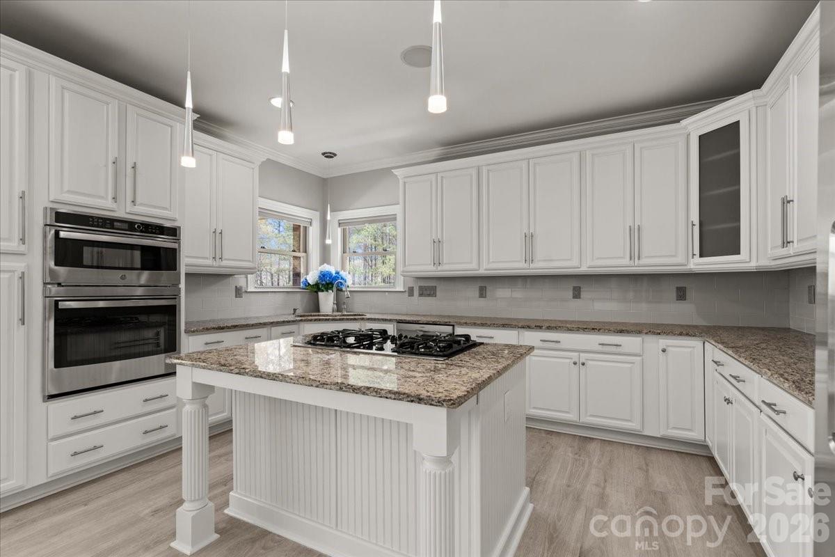 962 Miller Road Jefferson, SC 29718 - Photo 20 of 48 a kitchen with stainless steel appliances granite countertop a stove a sink and a microwave