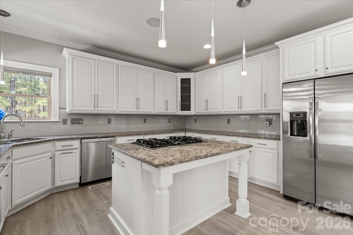 962 Miller Road Jefferson, SC 29718 - Photo 21 of 48 a kitchen with white cabinets stainless steel appliances and a window