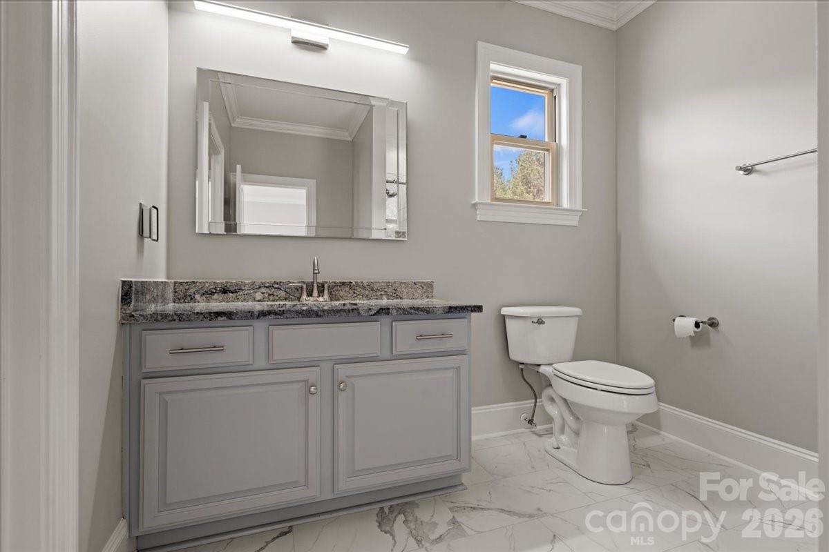962 Miller Road Jefferson, SC 29718 - Photo 37 of 48 a bathroom with a granite countertop toilet sink and mirror