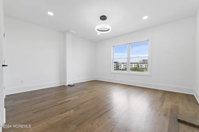 a dining room with furniture a chandelier and wooden floor