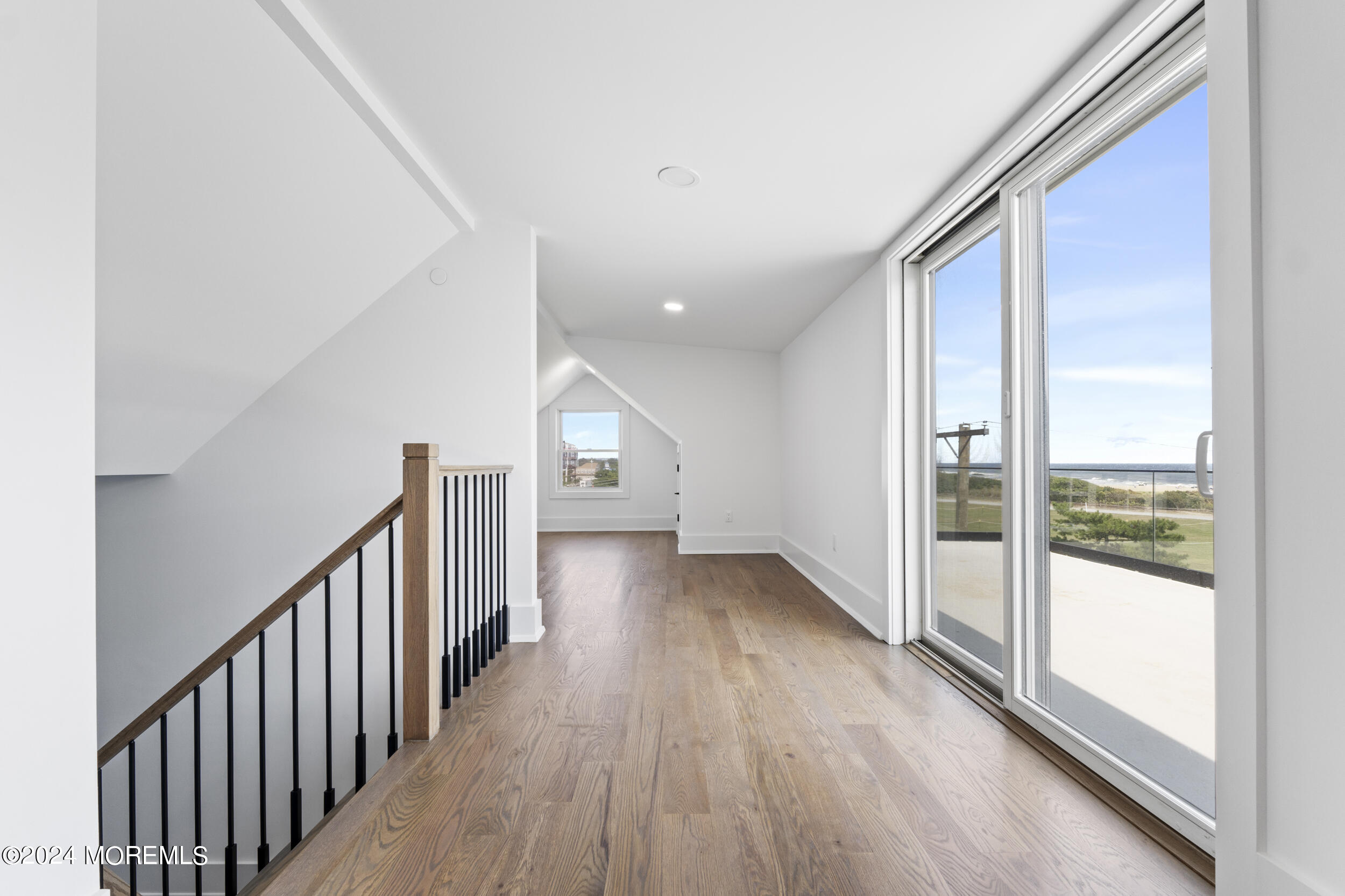 40 Seaview Avenue, Unit A Long Branch, NJ 07740 - Photo 51 of 62 a view of a hallway with wooden floor and windows
