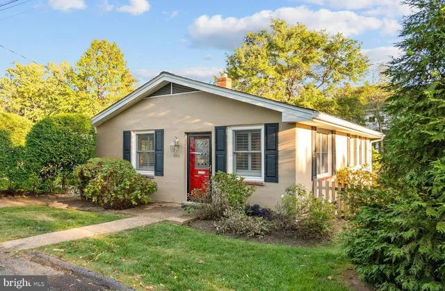a view of a house with brick walls and a yard with plants