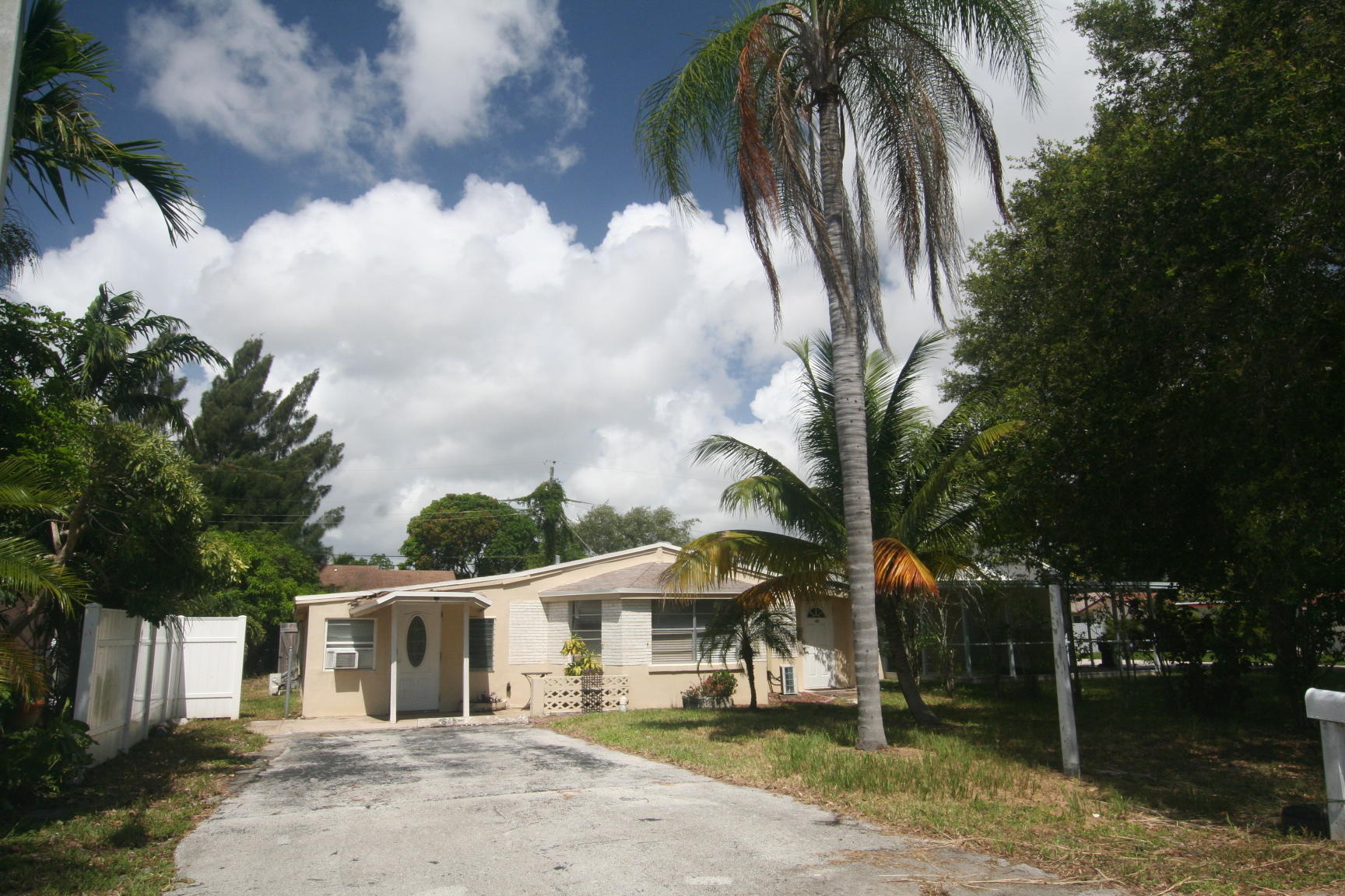 14925 Whatley Road Delray Beach, FL 33445 - Photo 2 of 8 a view of a white house with a yard and sitting area