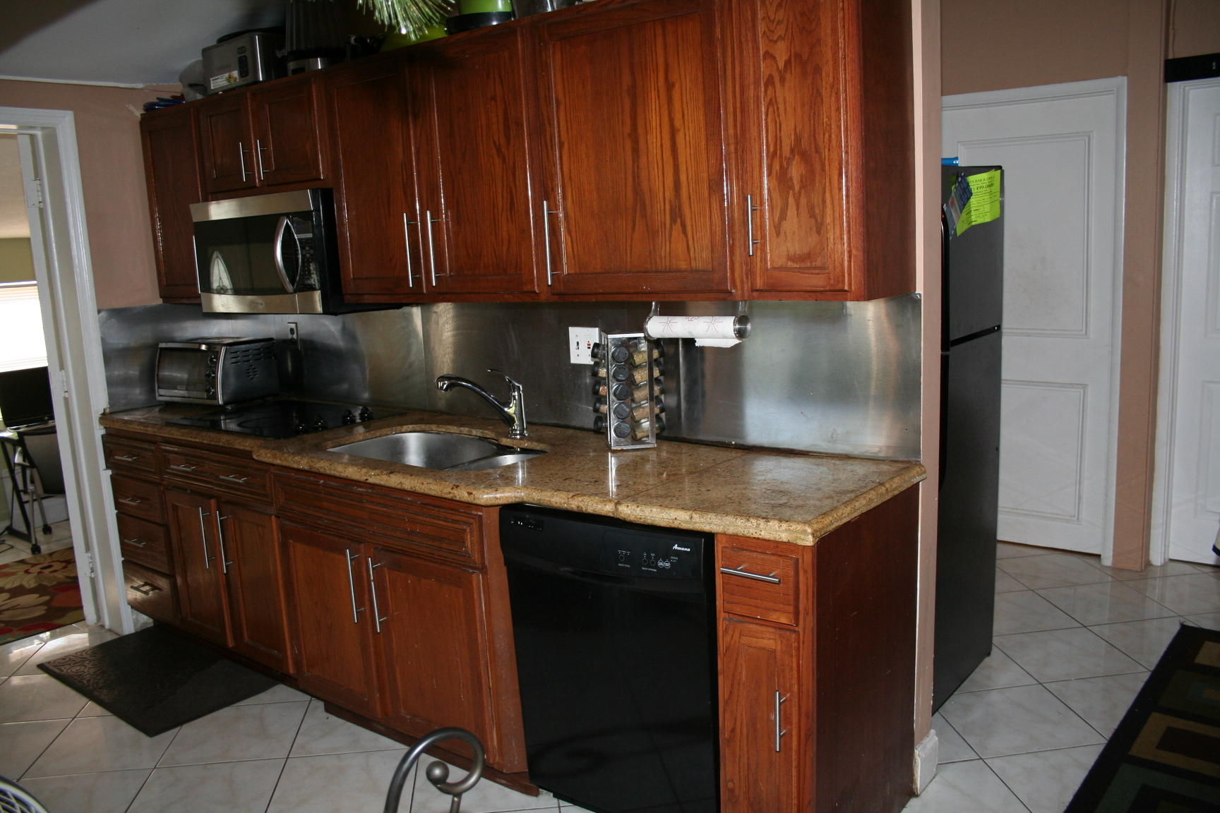14925 Whatley Road Delray Beach, FL 33445 - Photo 3 of 8 a kitchen with granite countertop a sink stainless steel appliances and cabinets
