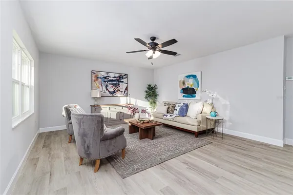 a living room with furniture and a wooden floor