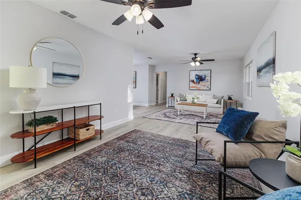 a living room with furniture and wooden floor