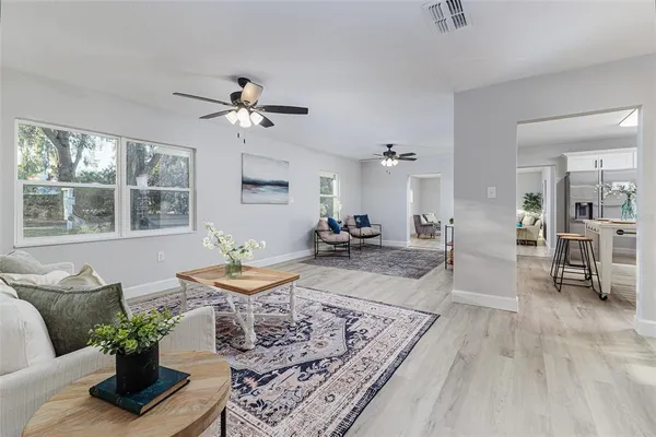 a living room with furniture and wooden floor