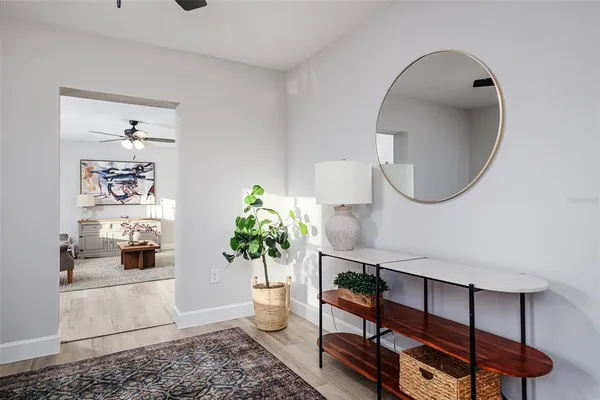 a living room with furniture and a mirror