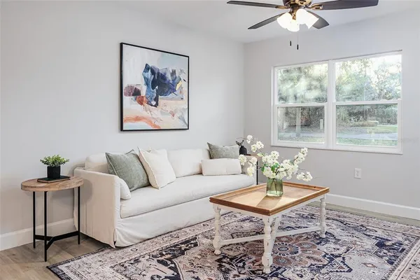 a living room with furniture a lamp and a table