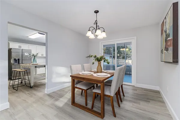 a view of a dining room with furniture wooden floor and a chandelier