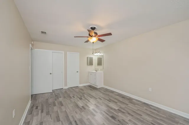 wooden floor in an empty room with a window