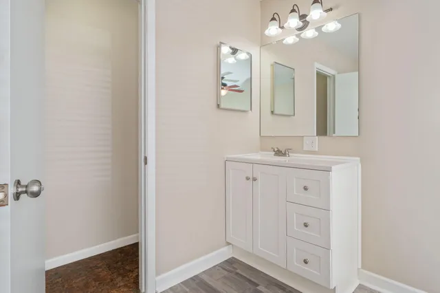 a bathroom with a sink vanity and mirror