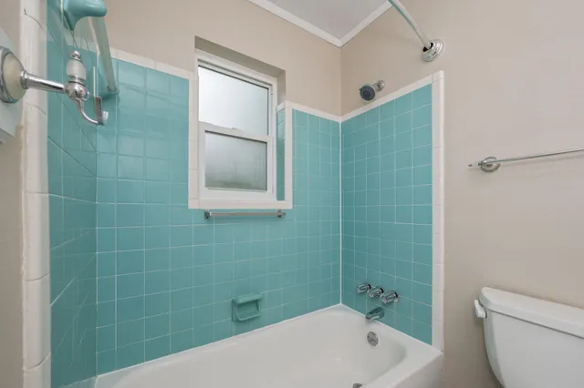 a bathroom with a bathtub and shower