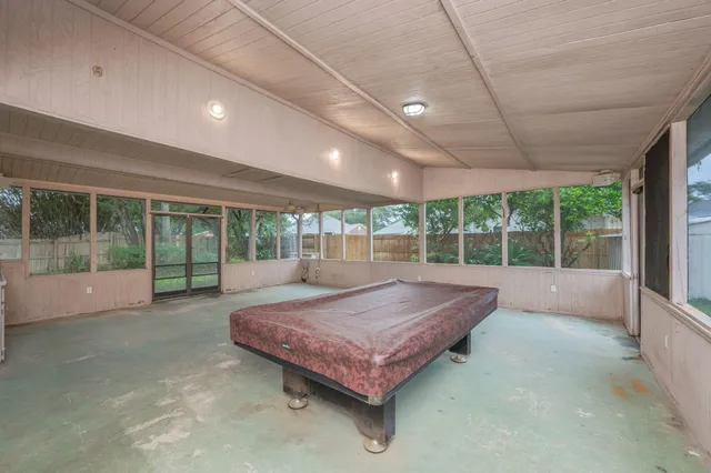 a spacious bedroom with a large bed and large windows