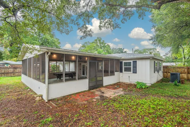 a view of a house with backyard and sitting area
