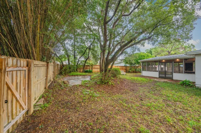 a view of a house with backyard and sitting area