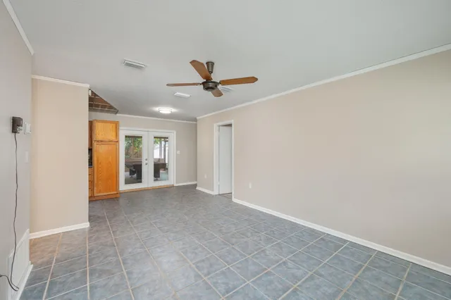 a view of a livingroom with a ceiling fan and window