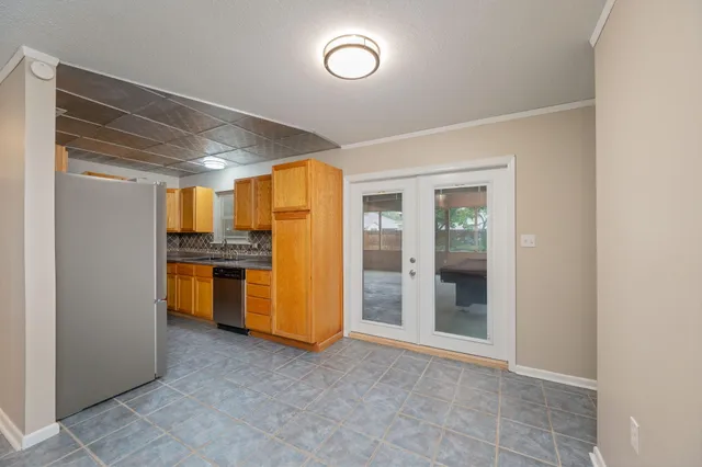 a view of a kitchen with a refrigerator a stove top oven