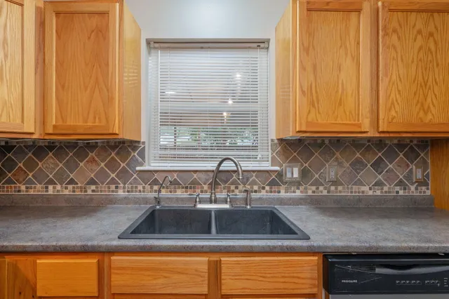 a kitchen with granite countertop a sink and a window