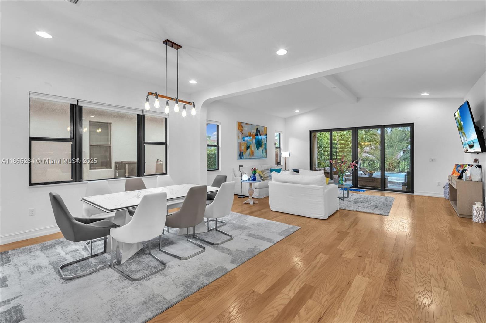 1281 Southwest 113th Way, Unit 1281 Pembroke Pines, FL 33025 - Photo 11 of 38 a living room with furniture and a chandelier