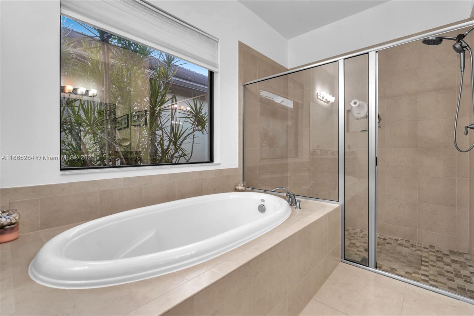 1281 Southwest 113th Way, Unit 1281 Pembroke Pines, FL 33025 - Photo 20 of 38 a white bath tub sitting next to a shower