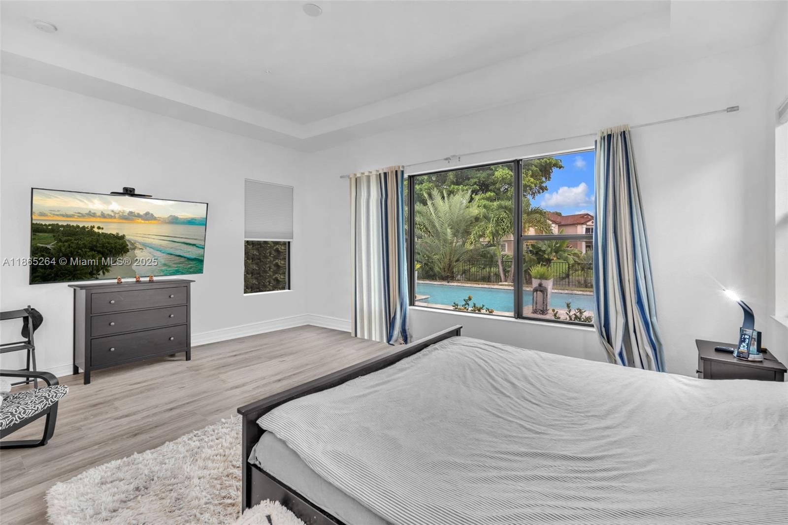 1281 Southwest 113th Way, Unit 1281 Pembroke Pines, FL 33025 - Photo 23 of 38 a bedroom with a bed and a flat screen tv