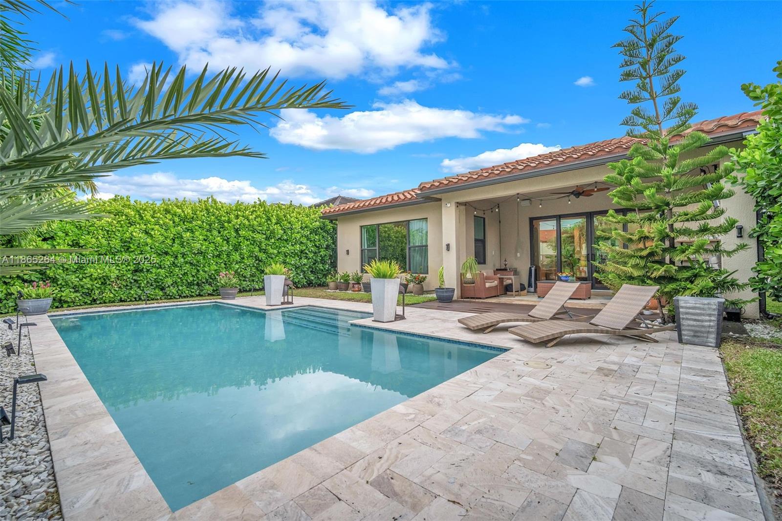 1281 Southwest 113th Way, Unit 1281 Pembroke Pines, FL 33025 - Photo 28 of 38 a view of a patio with swimming pool table and chairs