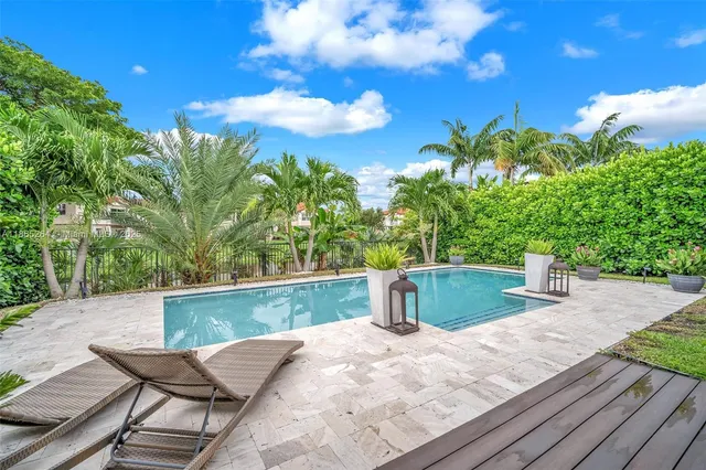 a view of a backyard with sitting area