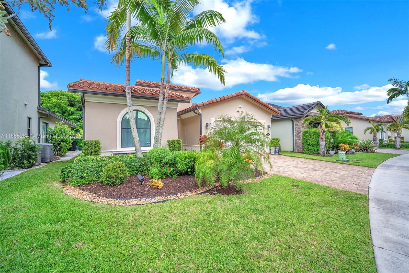 1281 Southwest 113th Way, Unit 1281 Pembroke Pines, FL 33025 - Photo 3 of 38 a view of a house with a yard and potted plants