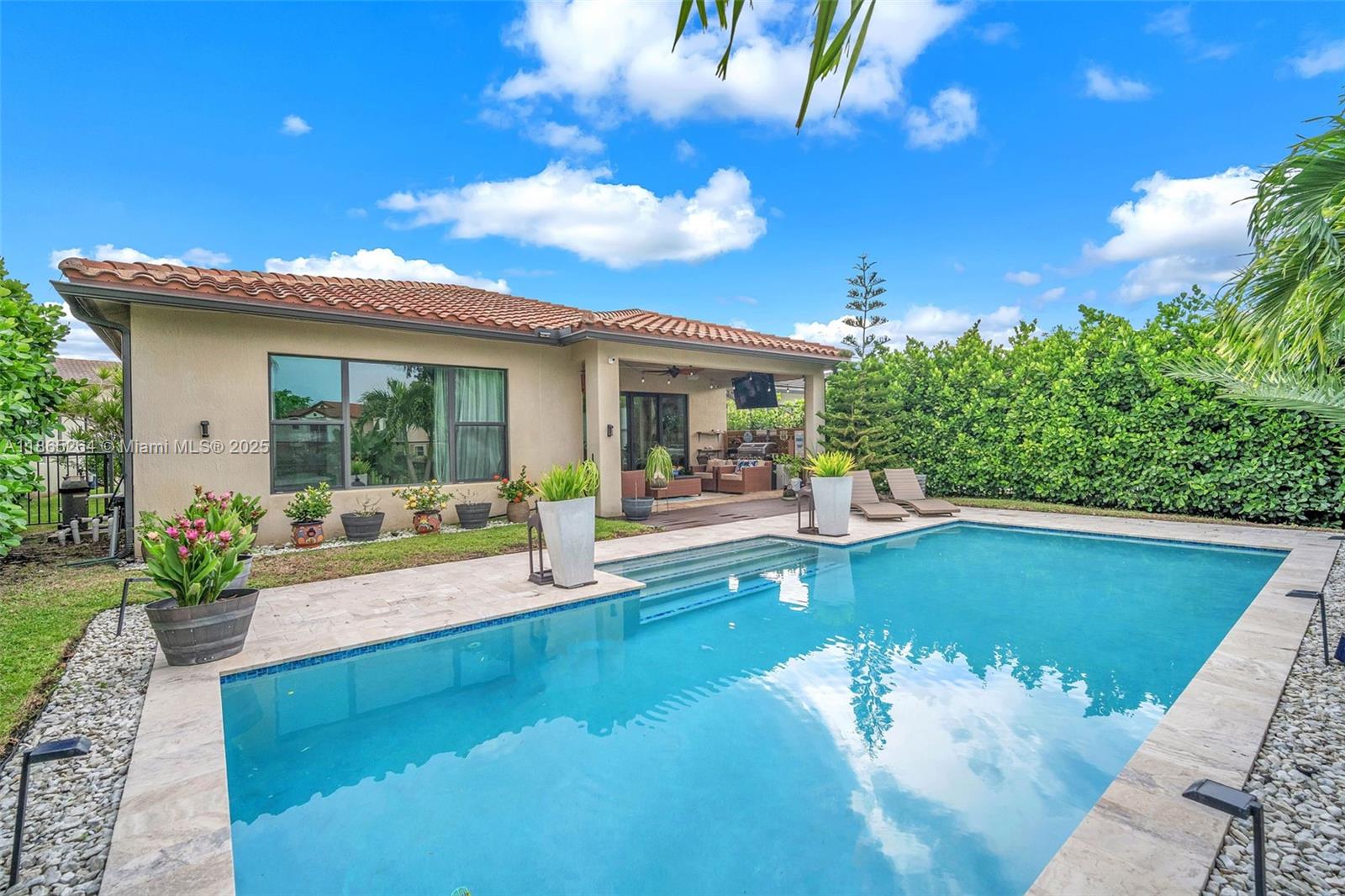 1281 Southwest 113th Way, Unit 1281 Pembroke Pines, FL 33025 - Photo 31 of 38 a view of a house with swimming pool and sitting area