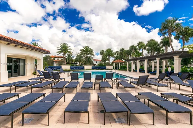 a view of a patio with tables and chairs