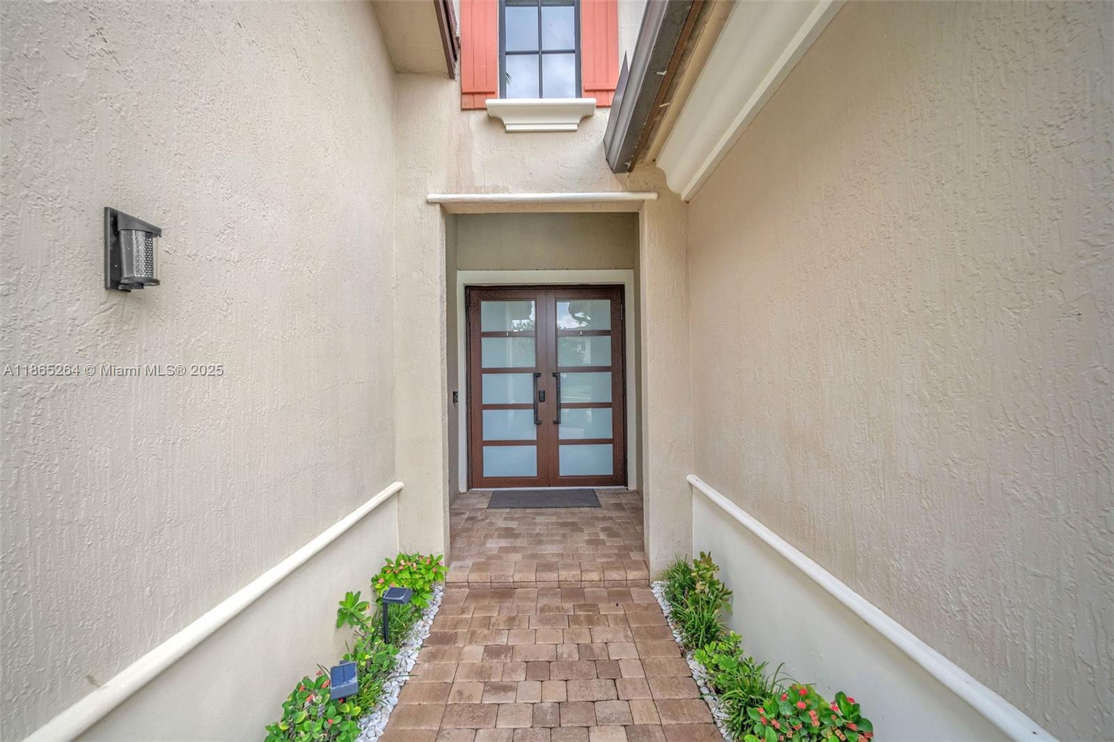1281 Southwest 113th Way, Unit 1281 Pembroke Pines, FL 33025 - Photo 5 of 38 a view of a hallway with wooden floor and plants