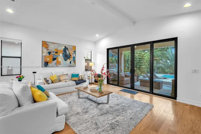 a living room with furniture and a floor to ceiling window