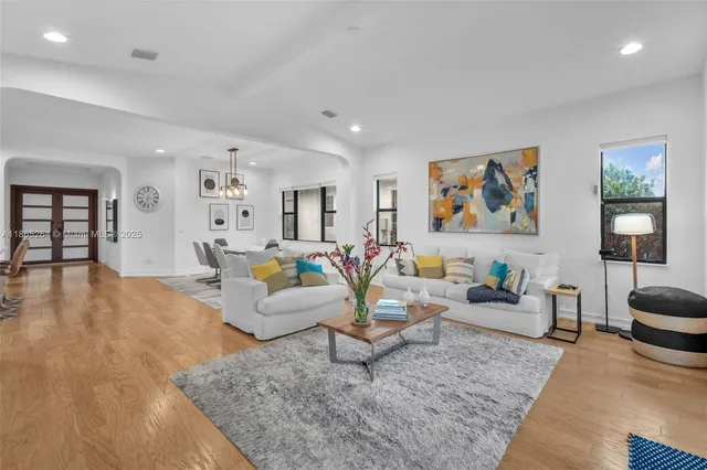 a living room with furniture and a wooden floor