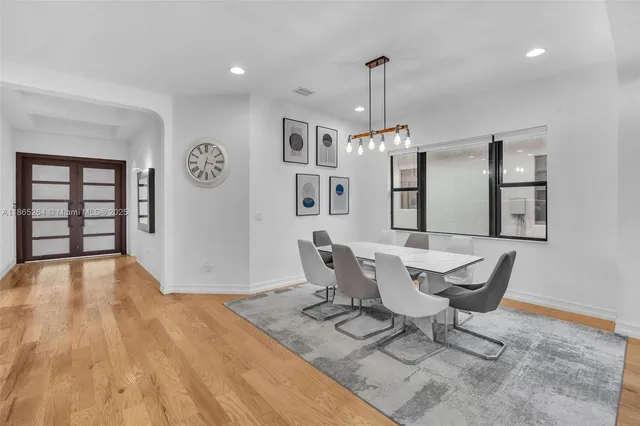 a view of a dining room with furniture and a chandelier