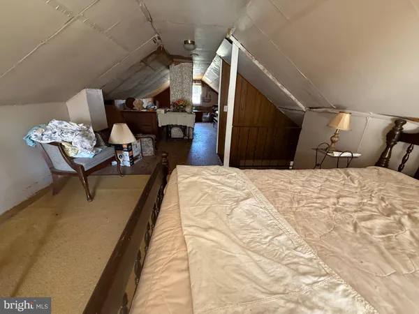 a bed room with a bed and chair