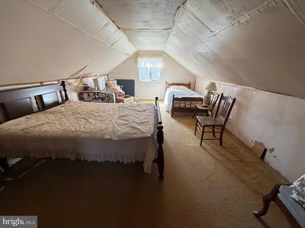 a bed sitting in a bedroom next to a chair
