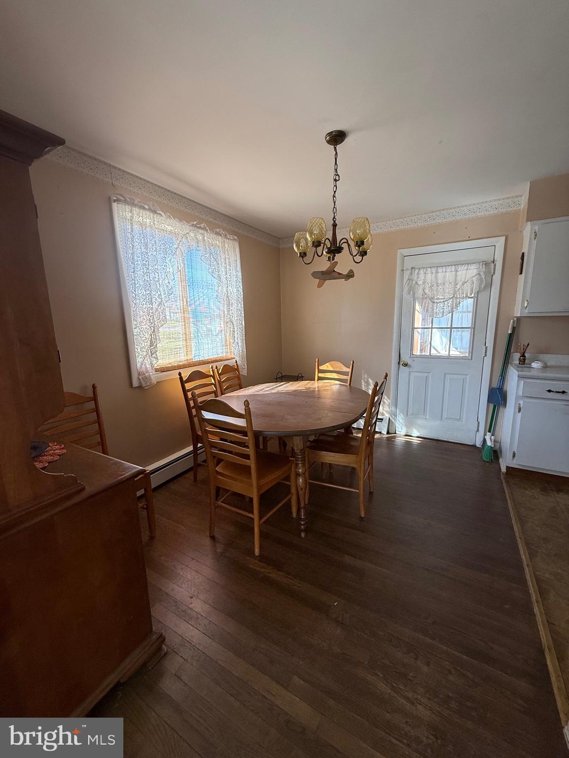 283 Kelton Road West Grove, PA 19390 - Photo 10 of 17 a dining room with furniture a chandelier and wooden floor