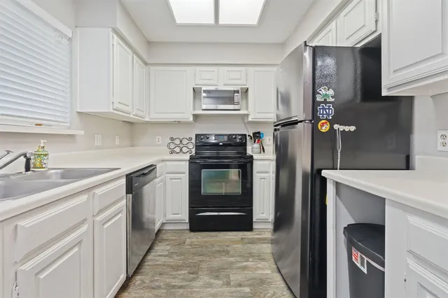 a kitchen with stainless steel appliances granite countertop a stove and a refrigerator