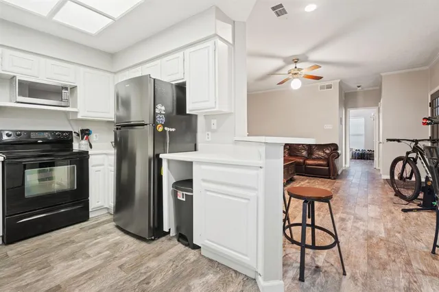 a kitchen with stainless steel appliances a stove a refrigerator and a sink
