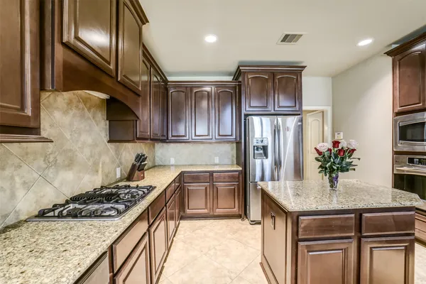 a view of a workspace with furniture and a book shelf