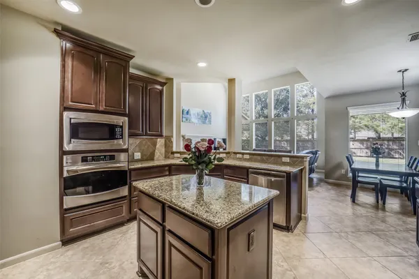 a view of a livingroom with furniture window wooden floor and chandelier
