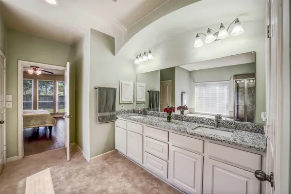 a view of a yard with a large trees and wooden fence