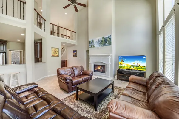 a living room with furniture a flat screen tv and a fireplace