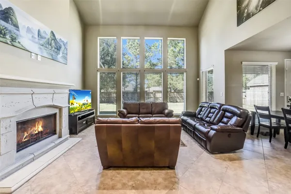 a living room with furniture ceiling fan and a rug