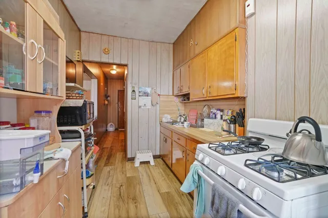 a living room with furniture a flat screen tv and a window