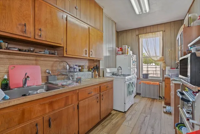 a bedroom with a bed and flat tv screen