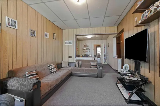 a bedroom with a bed dresser and a window